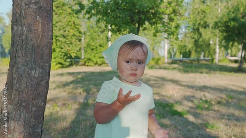 A little girl 2 years old sends an air kiss