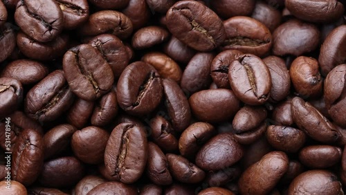 Coffee beans close up. Rotation of roasted coffee beans close-up.