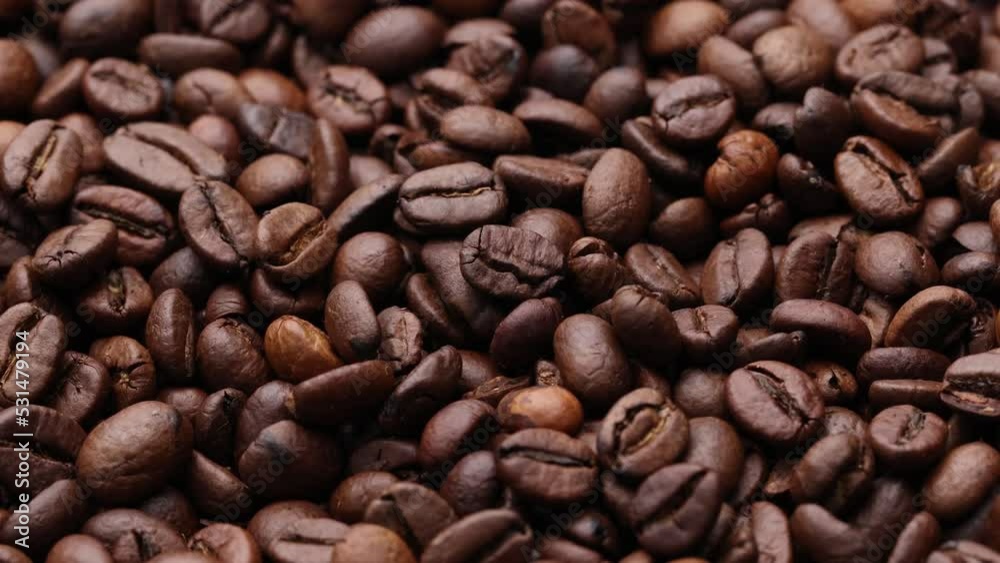 Coffee beans close up. Rotation of roasted coffee beans close-up. Coffee beans close up. Rotation of roasted coffee beans close-up.