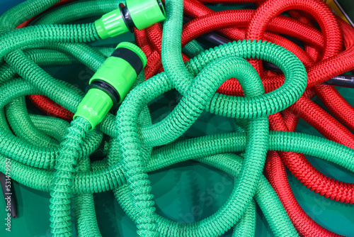 Green and red corrugated hoses. Inventory and tools.