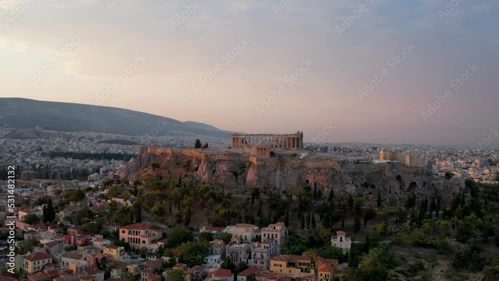 Aerial view Acropolis in Athens, Greece, sunrise in summer. Drone shot of golden sun rays hitting history rich Parthenon. Panorama of the Greek capital, flyover in the peaceful morning sea background Aerial view Acropolis in Athens, Greece, sunrise in summer. Drone shot of golden sun rays hitting history rich Parthenon. Panorama of the Greek capital, flyover in the peaceful morning sea background