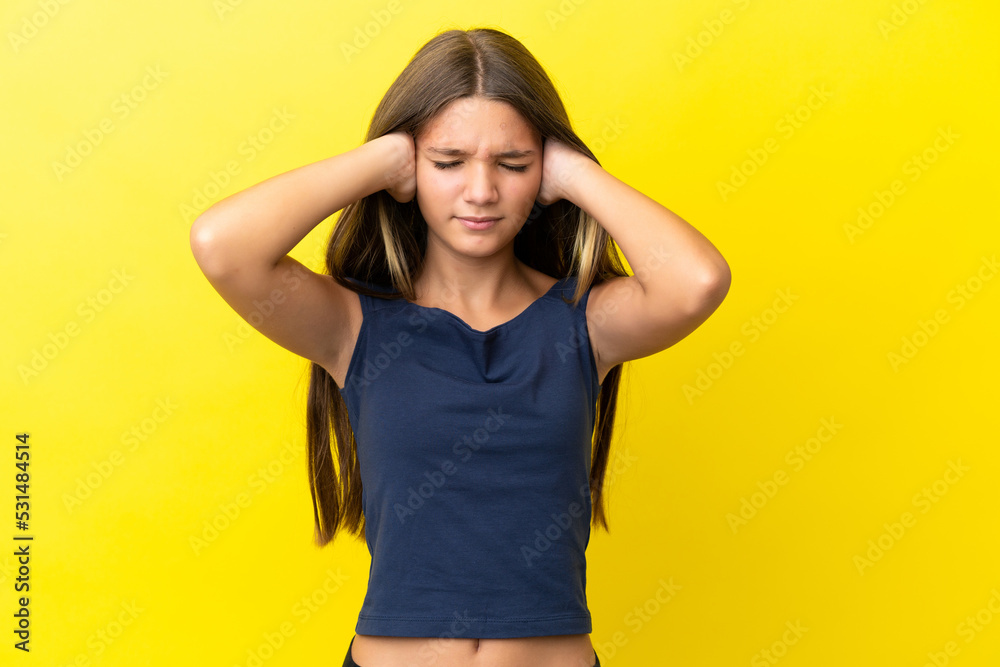 Little caucasian girl isolated on yellow background frustrated and covering ears Little caucasian girl isolated on yellow background frustrated and covering ears
