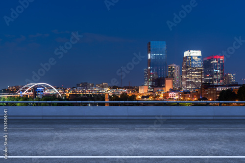 Empty urban asphalt road exterior with city buildings background. New modern highway concrete construction. Concept of way to success. Transportation logistic industry fast delivery. Nashville. USA.