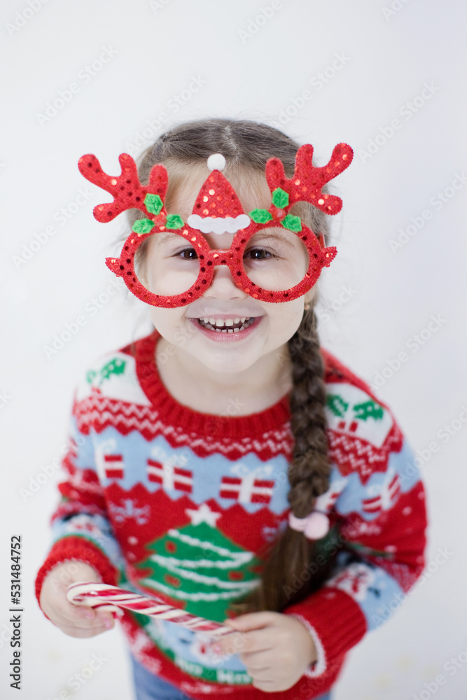 Preschool caucasian girl in Christmas sweater Preschool caucasian girl in Christmas sweater