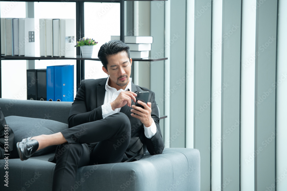 Young entrepreneurs in Asia Take a break to relax in the relaxation room after a meeting. By watching movies, taking photos, talking Young entrepreneurs in Asia Take a break to relax in the relaxation room after a meeting. By watching movies, taking photos, talking
