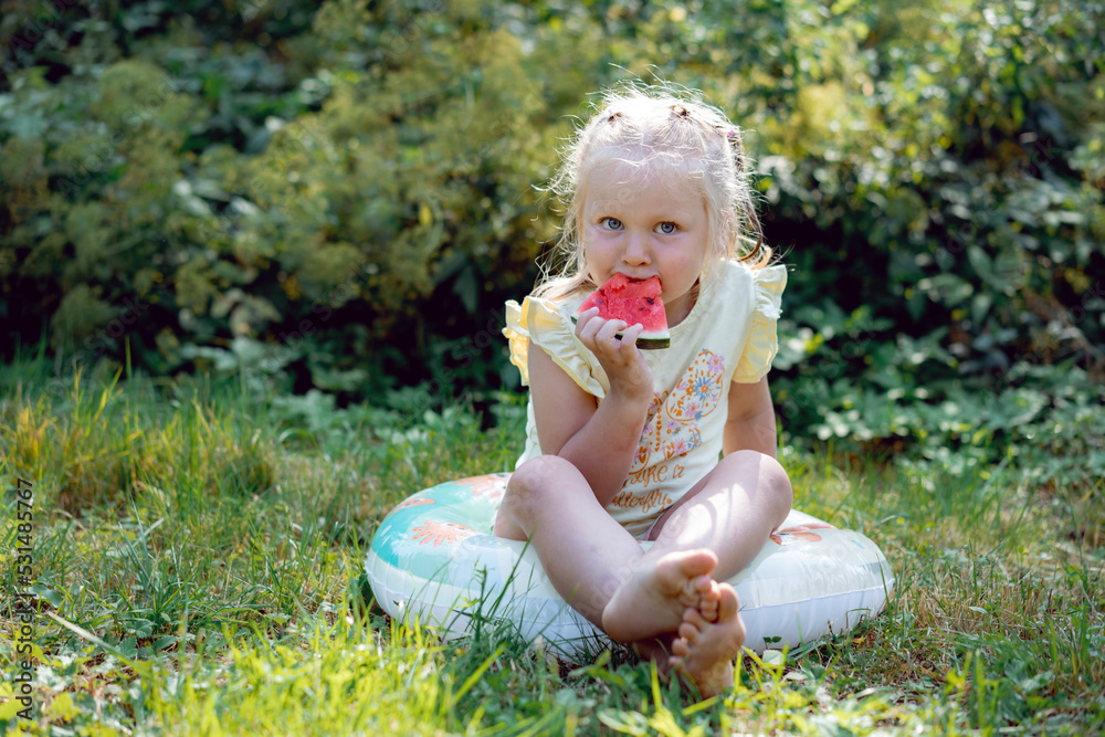 cute caucasian girl eating watermelon in countryside