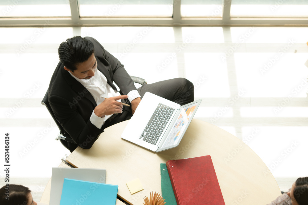 Boss is having a meeting to review investment information with the team in a meeting room with natural light Boss is having a meeting to review investment information with the team in a meeting room with natural light