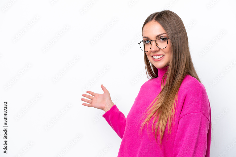 Young caucasian woman isolated on white background extending hands to the side for inviting to come Young caucasian woman isolated on white background extending hands to the side for inviting to come