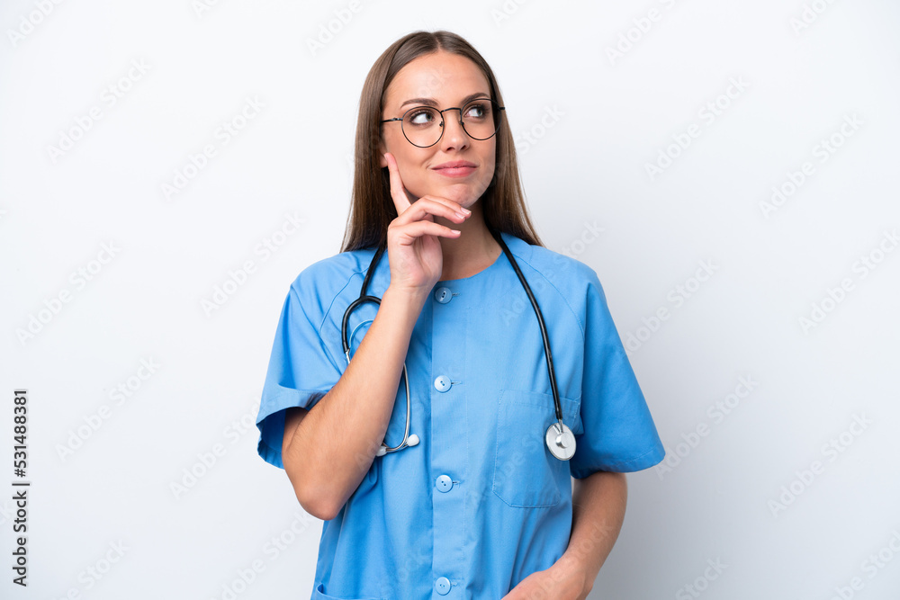 Young nurse caucasian woman isolated on white background thinking an idea while looking up Young nurse caucasian woman isolated on white background thinking an idea while looking up