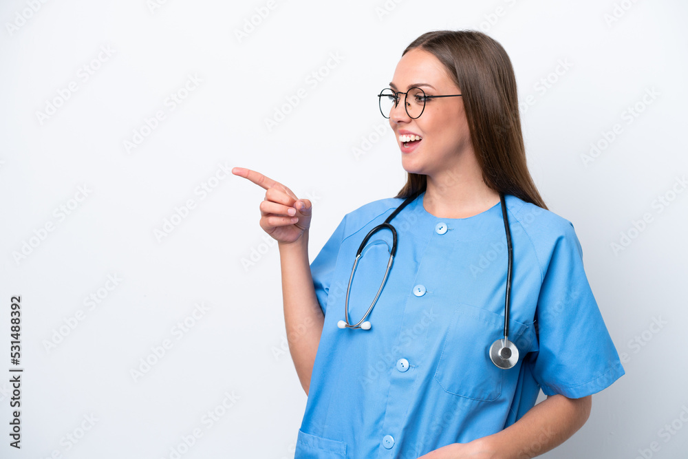 Young nurse caucasian woman isolated on white background pointing finger to the side and presenting a product Young nurse caucasian woman isolated on white background pointing finger to the side and presenting a product