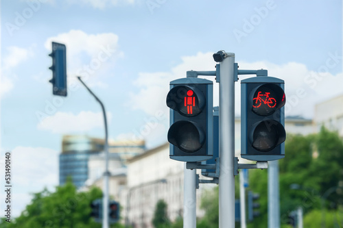 Pedestrian and bicycle traffic light on city street, space for text