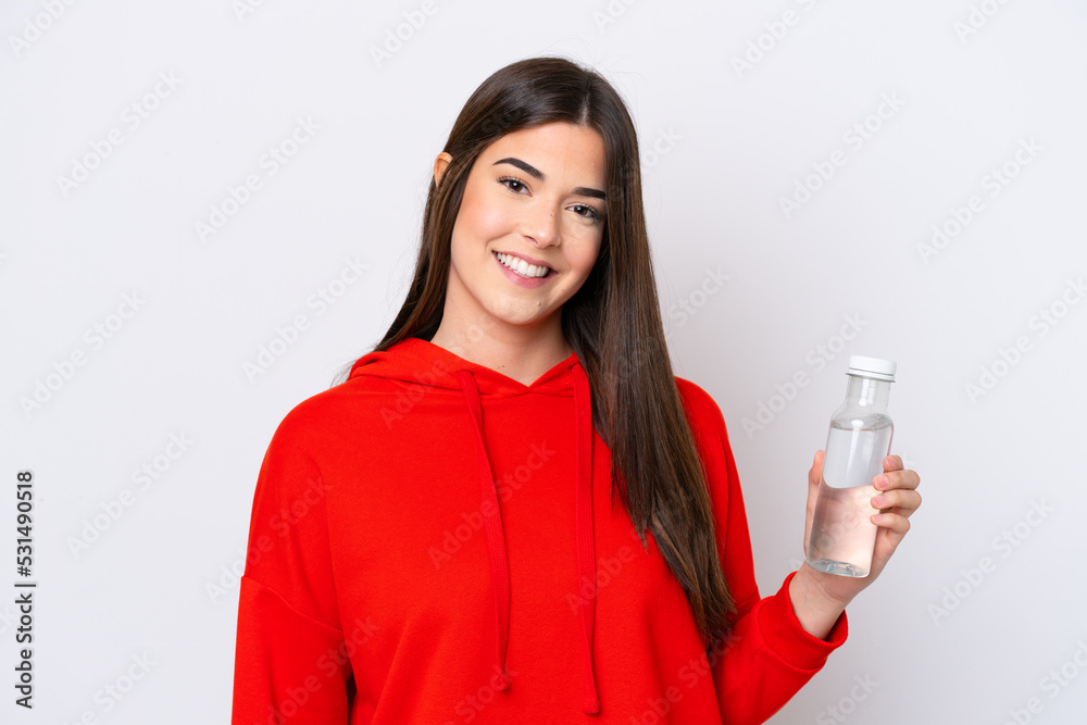 Young Brazilian woman with a bottle of water isolated on white background smiling a lot Young Brazilian woman with a bottle of water isolated on white background smiling a lot