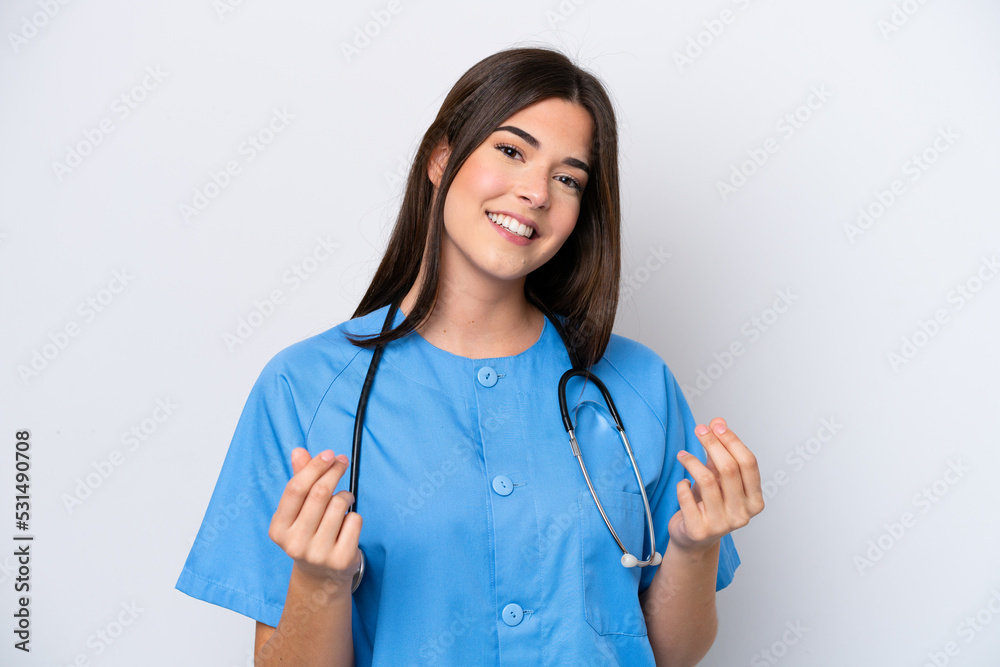 Young Brazilian nurse woman isolated on white background making money gesture Young Brazilian nurse woman isolated on white background making money gesture