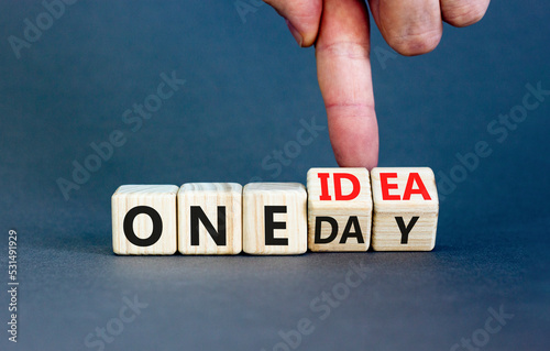 One day and idea symbol. Concept words One day and One idea on wooden cubes. Businessman hand. Beautiful grey table grey background. Business One day and idea concept. Copy space.