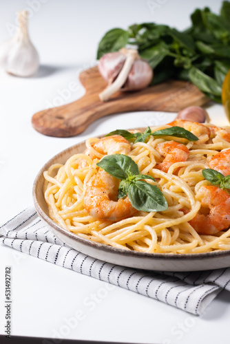 Italian pasta spaghetti with soft cheese sauce with shrimp or prawns on a plate