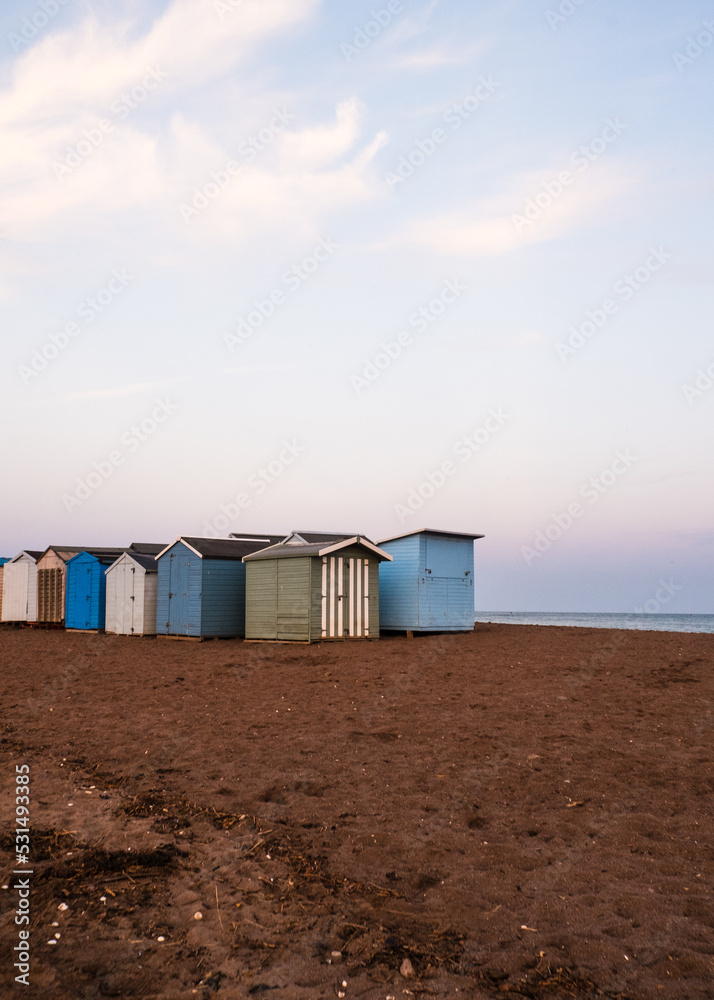 Beach Huts On Teignmouth's Back Beach At Sunset