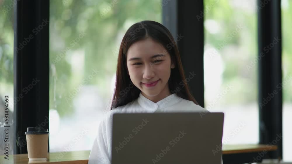 Young beautiful is studying online via laptop and writing on note book at home. Young beautiful is studying online via laptop and writing on note book at home.