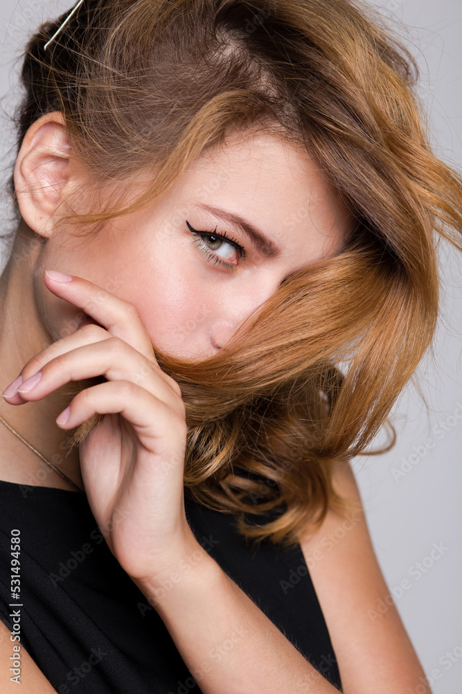 High fashion photo of a beautiful elegant young woman in a pretty black jumpsuit on white background. Studio Shot. High fashion photo of a beautiful elegant young woman in a pretty black jumpsuit on white background. Studio Shot.