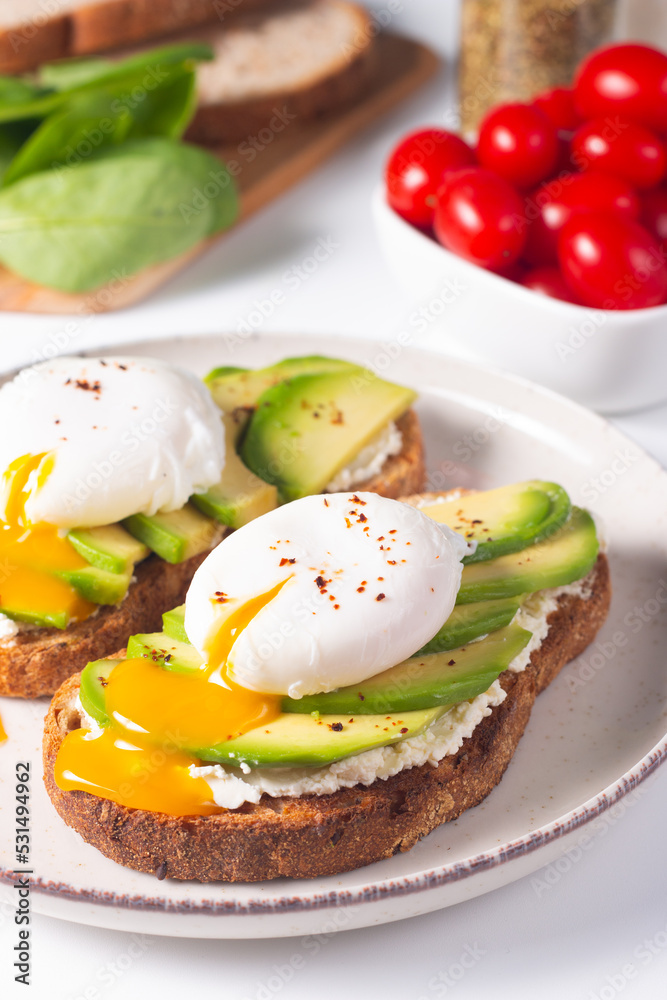 Two avocado open sandwiches with egg. Keto and diet concept. Healthy toast food for breakfast. Two avocado open sandwiches with egg. Keto and diet concept. Healthy toast food for breakfast.