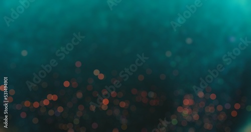Bokeh light overlay. Blur circles texture. Glowing sparkles. Defocused verdigris green blue red color round particles on dark abstract background. photo