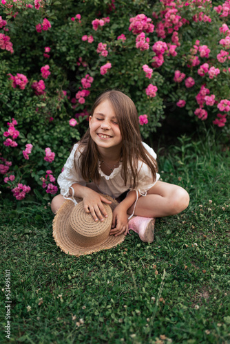 beautiful girl among pink roses outside