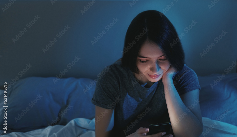 Digital life. Insomnia woman. Sleepless night. Bored relaxed lady scrolling smartphone in bed light shadow home interior. Digital life. Insomnia woman. Sleepless night. Bored relaxed lady scrolling smartphone in bed light shadow home interior.