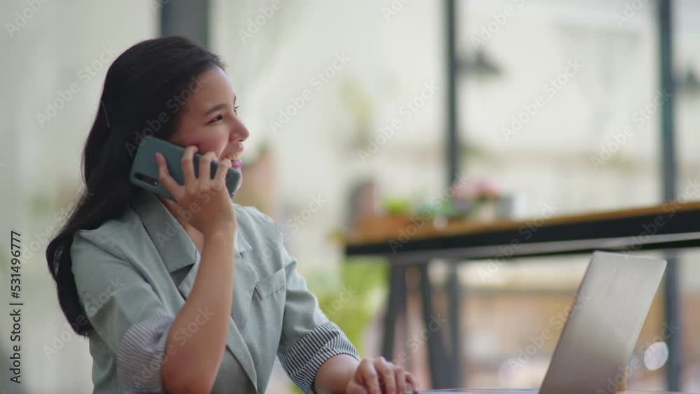 Young business women working and talking on a phone calling with happy and smile face on office space. Young business women working and talking on a phone calling with happy and smile face on office space.