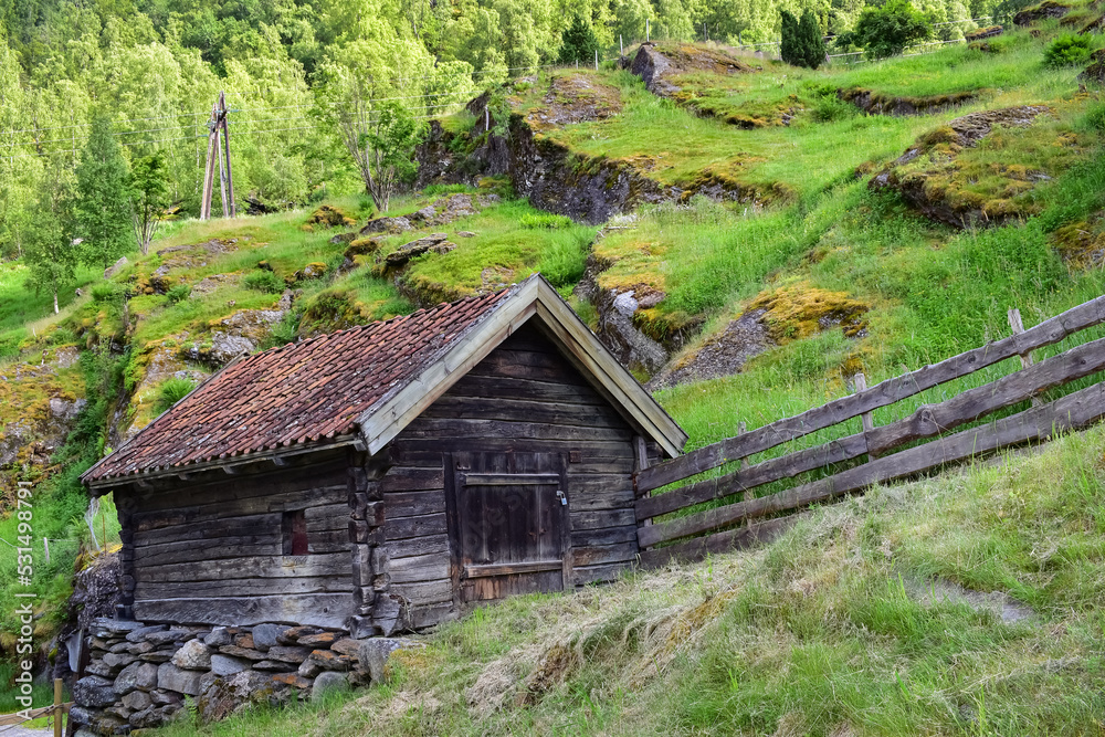 Old wooden shed in hilly landscape Old wooden shed in hilly landscape