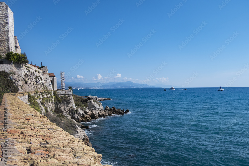 Beautiful Mediterranean coastline under blue sky in Antibes - city on French Riviera between Cannes and Nice.