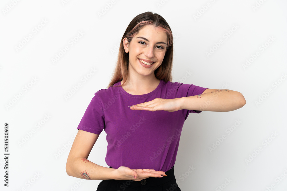 Young caucasian woman isolated on white background holding copyspace imaginary on the palm to insert an ad Young caucasian woman isolated on white background holding copyspace imaginary on the palm to insert an ad