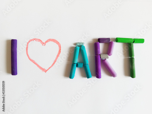 phrase  I love art  made by colorful pastel crayons on a white background