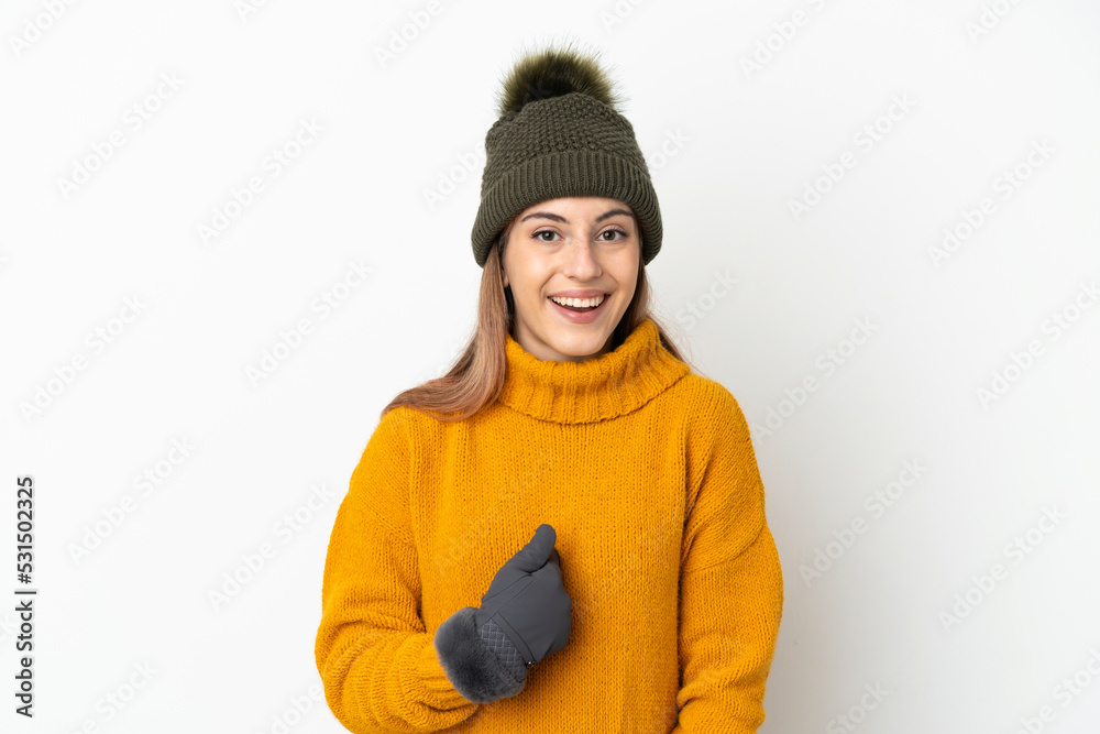 Young girl with winter hat isolated on white background with surprise facial expression Young girl with winter hat isolated on white background with surprise facial expression