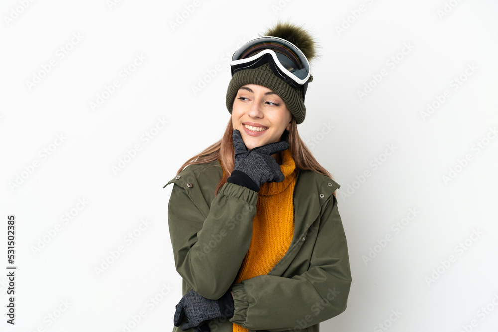 Skier caucasian woman with snowboarding glasses isolated on white background looking to the side and smiling Skier caucasian woman with snowboarding glasses isolated on white background looking to the side and smiling