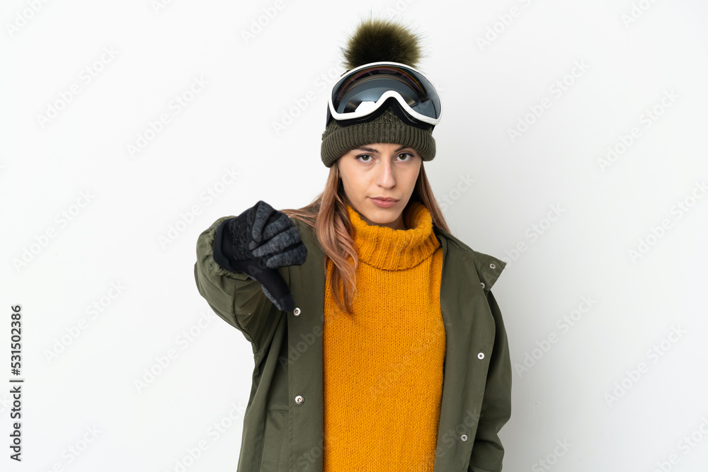 Skier caucasian woman with snowboarding glasses isolated on white background showing thumb down with negative expression Skier caucasian woman with snowboarding glasses isolated on white background showing thumb down with negative expression