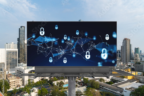 Padlock icon hologram on road billboard over panorama city view of Bangkok at day time to protect business, Southeast Asia. The concept of information security shields.