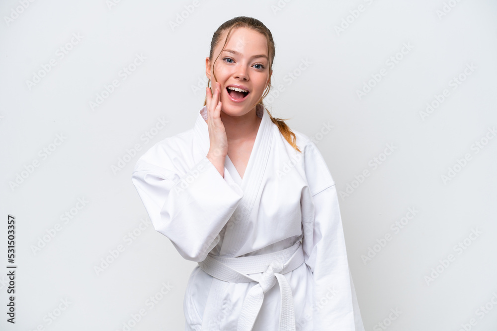 Young caucasian girl doing karate isolated on white background with surprise and shocked facial expression Young caucasian girl doing karate isolated on white background with surprise and shocked facial expression