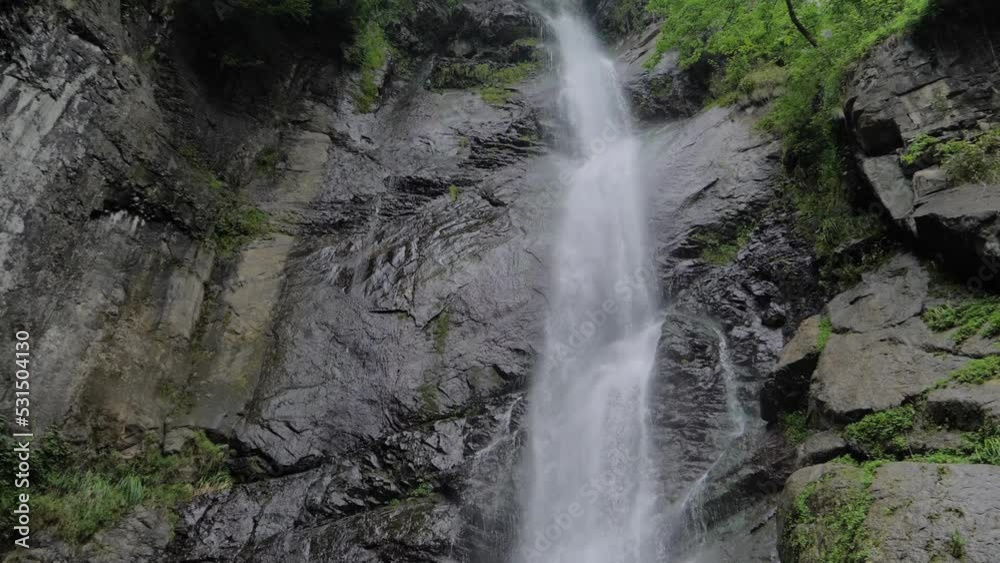 Makhuntseti waterfall in the mountain in Batumi, Georgia - river or stream of water flowing and falling down: wide angle view, slow motion. Nature, landscape and environment concept Makhuntseti waterfall in the mountain in Batumi, Georgia - river or stream of water flowing and falling down: wide angle view, slow motion. Nature, landscape and environment concept