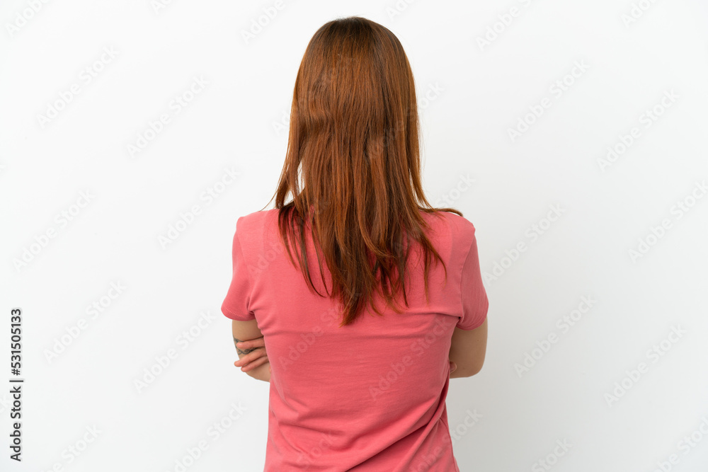 Redhead girl isolated on white background in back position Redhead girl isolated on white background in back position