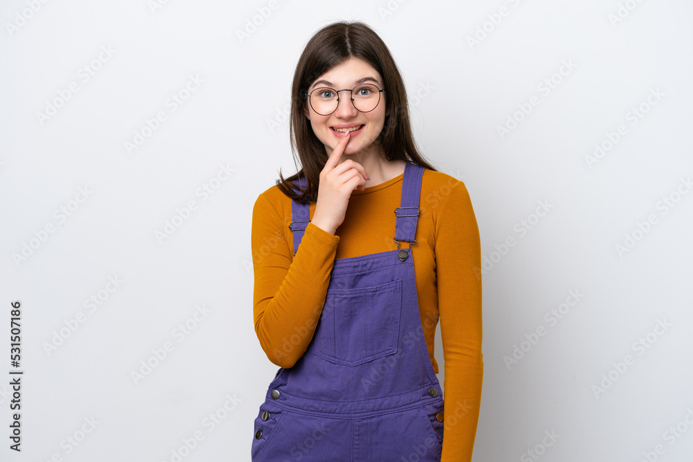 Young Russian woman isolated on blue background showing a sign of silence gesture putting finger in mouth Young Russian woman isolated on blue background showing a sign of silence gesture putting finger in mouth