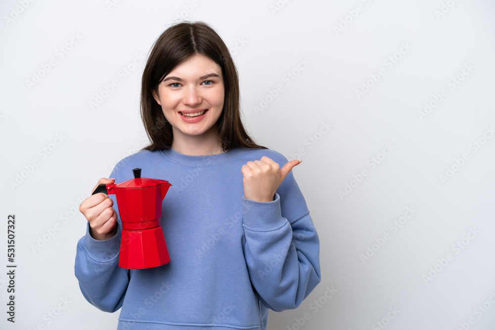 Young Russian woman holding coffee pot isolated on white background pointing to the side to present a product Young Russian woman holding coffee pot isolated on white background pointing to the side to present a product