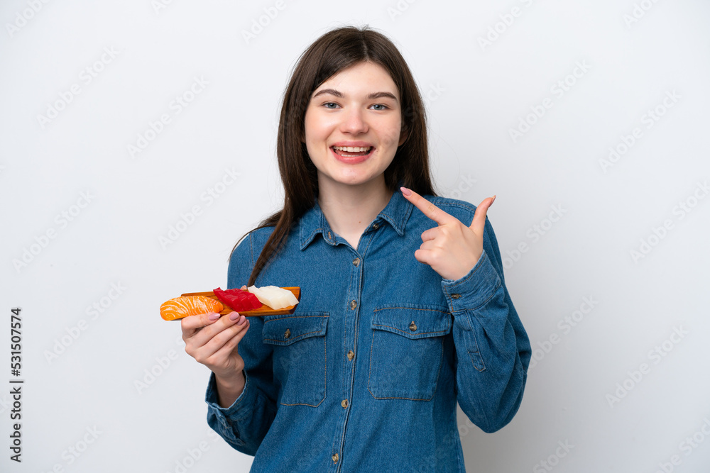 Young Russian woman holding sashimi isolated on white background giving a thumbs up gesture Young Russian woman holding sashimi isolated on white background giving a thumbs up gesture