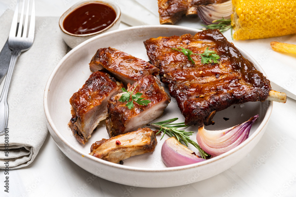 Grilled pork ribs with barbecue sauce and ketchup and grilled vegetables	
