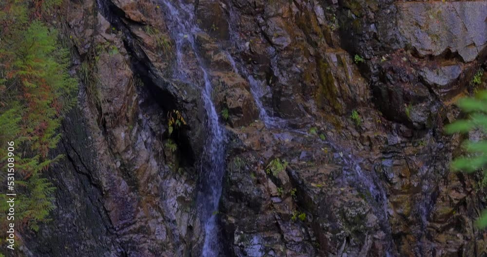 Establishing shot of majestic mountain waterfall with mountain background in Vancouver, Canada, North America. Day time on July 2021. ProRes 422 HQ. Establishing shot of majestic mountain waterfall with mountain background in Vancouver, Canada, North America. Day time on July 2021. ProRes 422 HQ.