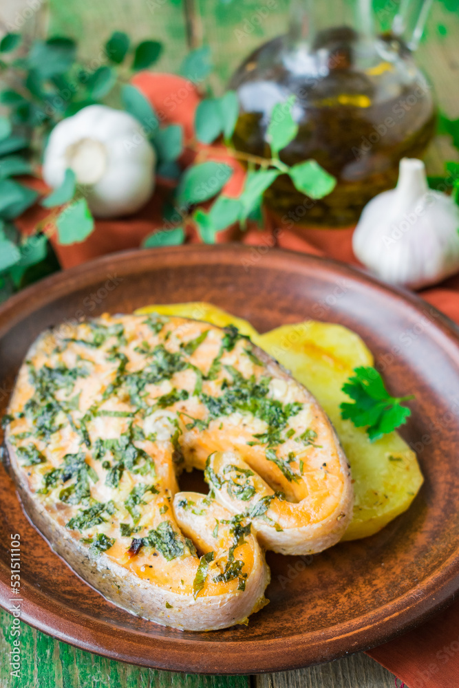 Baked salmon steak with potatoes and parsley Baked salmon steak with potatoes and parsley