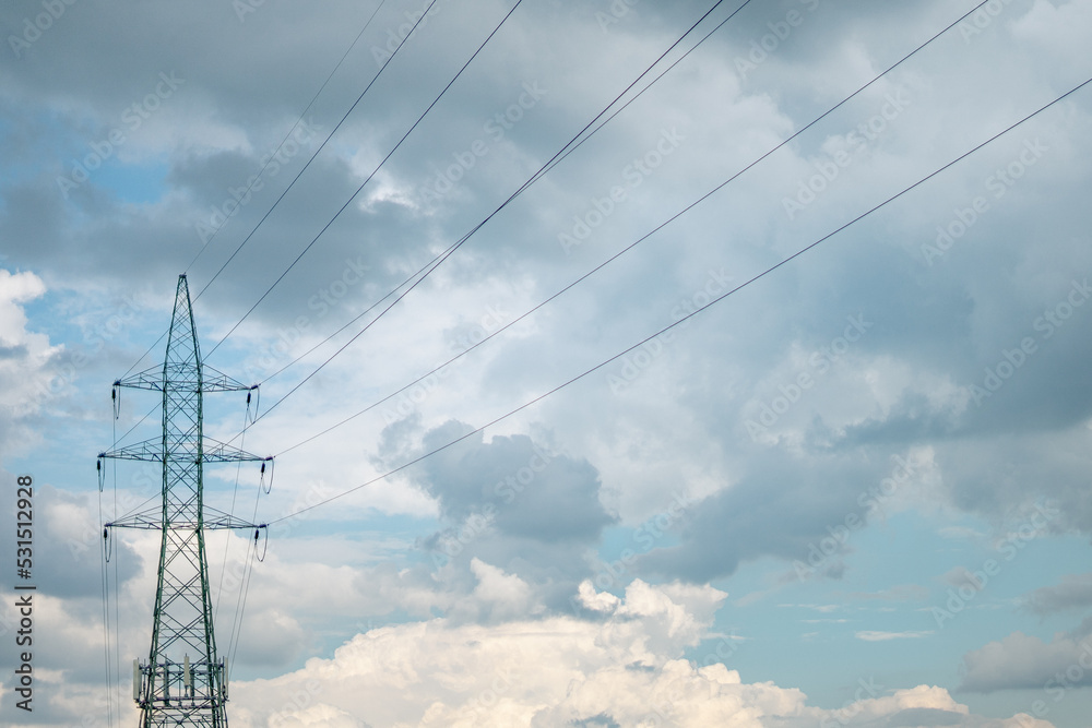 electricity transmission pylon silhouetted against blue sky at day electricity transmission pylon silhouetted against blue sky at day