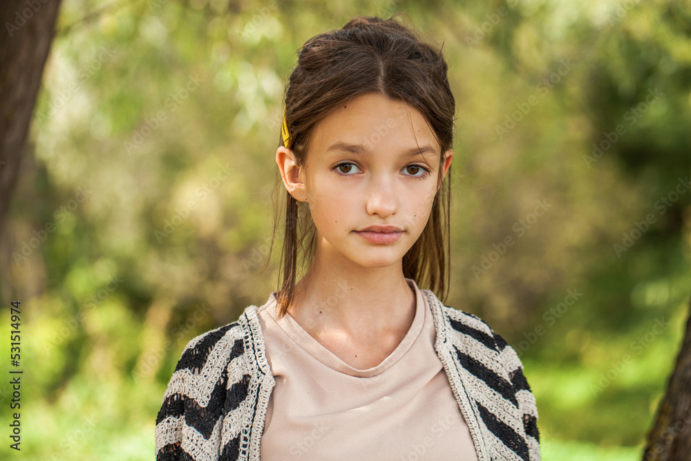 Portrait of a teenage girl, summer park outdoors Portrait of a teenage girl, summer park outdoors