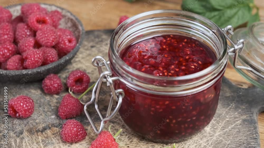 Raspberry jam in a jar with fresh berries. Sweet food. Tasty dessert. 4k video Raspberry jam in a jar with fresh berries. Sweet food. Tasty dessert. 4k video