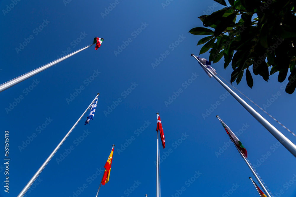 Some European flags waving in the blue sky