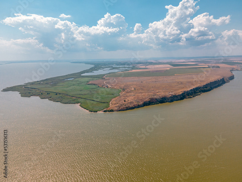 erial view of Dolosman Cape with Argamum fortress located in Tulcea county, Romania by the Lake Razim. Photography was taken from a drone in mid day, in a sunny weather, summer time. photo