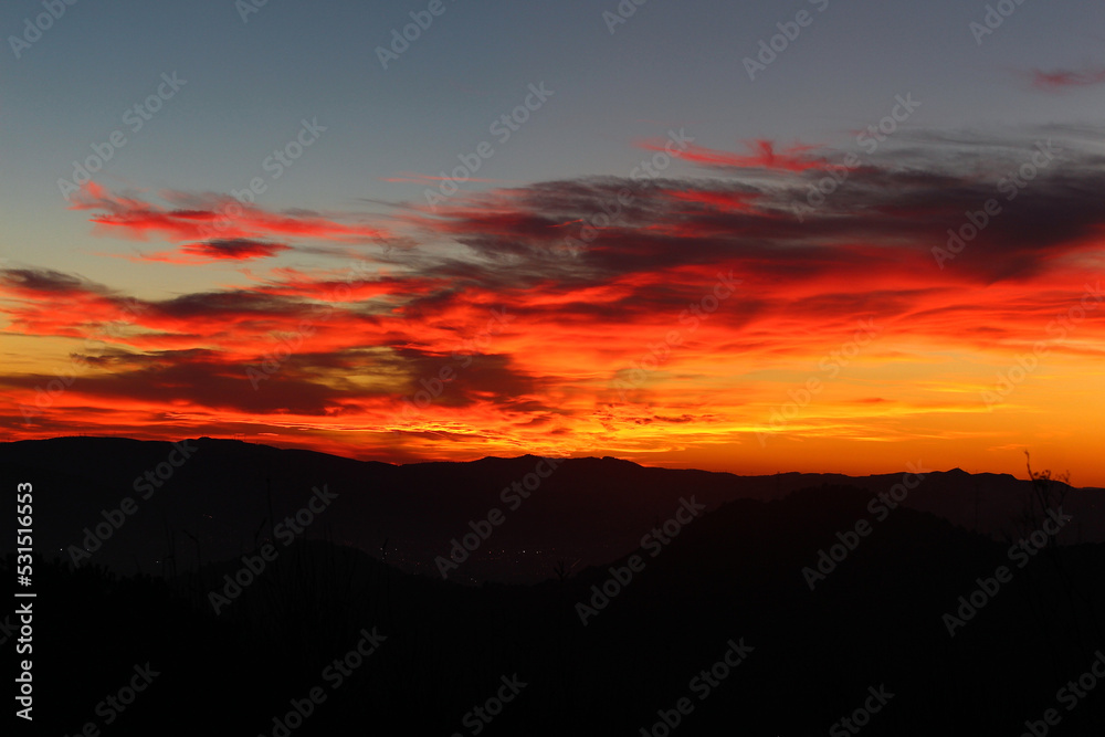 Red and orange sunset with mountains